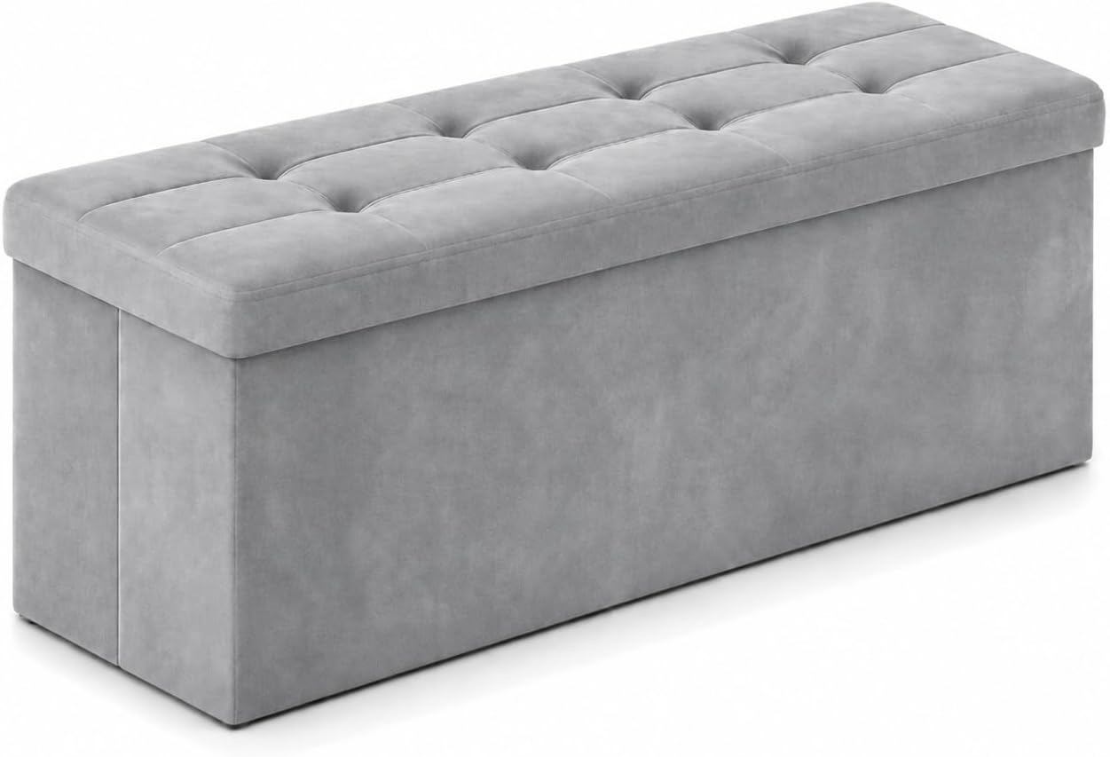 Light grey rectangular tufted storage ottoman angled to show the front and top.