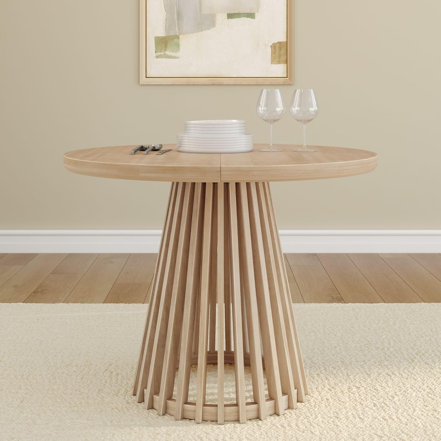Front view of round table in blonde finish highlighting the slatted pedestal base and tabletop seam