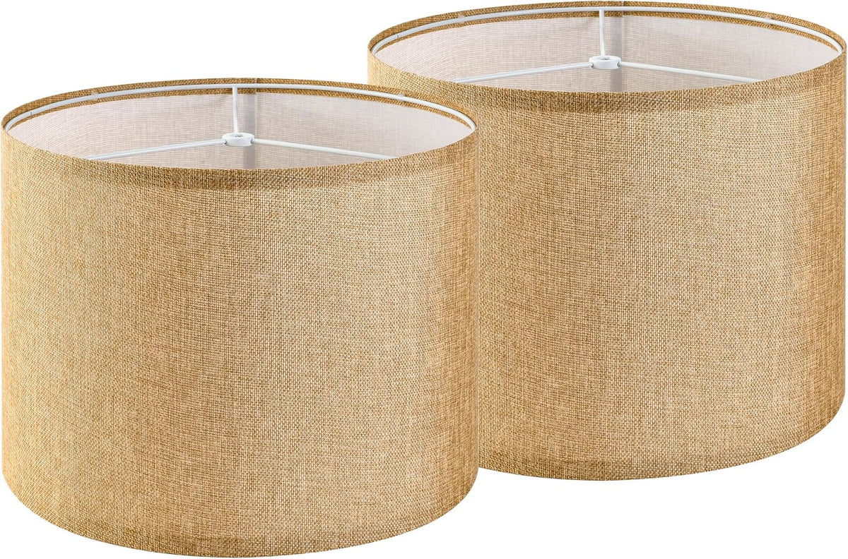 Two natural-colored linen drum lampshades side by side, showing woven texture and white interior.
