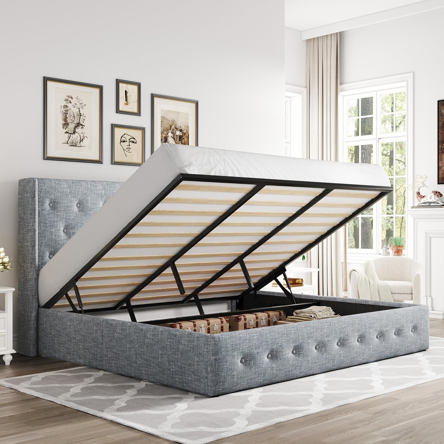 Three-quarter view of a light heather-gray upholstered storage bed with lifted mattress revealing internal storage.