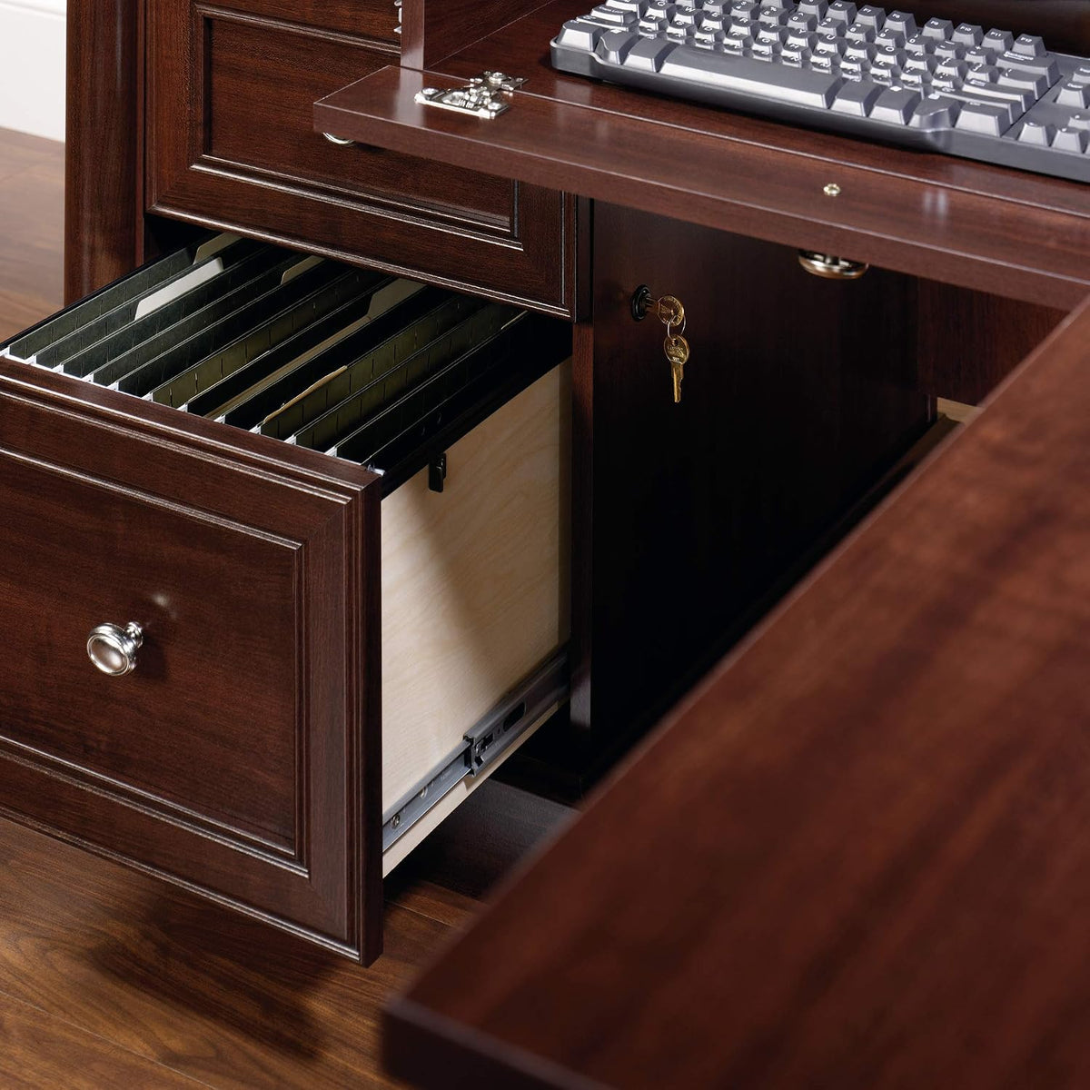 Close-up of open file drawer with hanging file rails and nearby locked compartment key