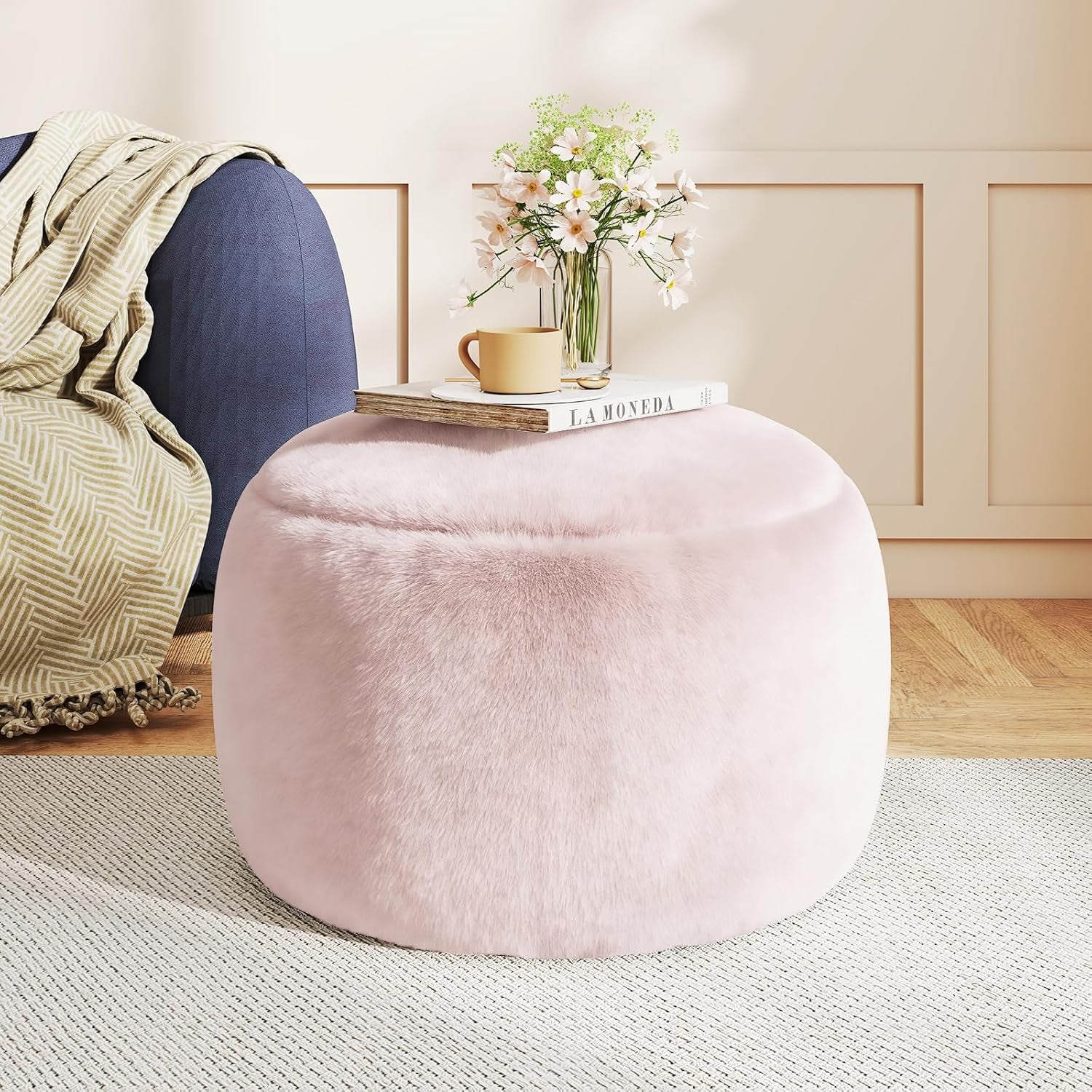 Orange-brown faux-fur pouf ottoman front view with book and vase on top