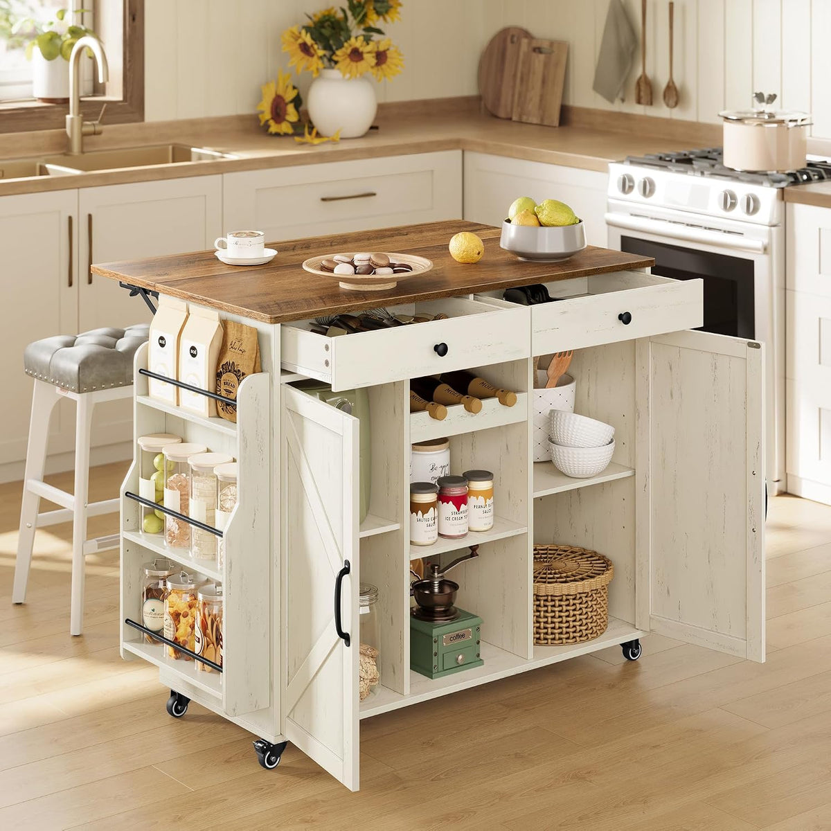 White-base kitchen island with brown wood top, doors open showing drawers and shelves, angled front view in a kitchen