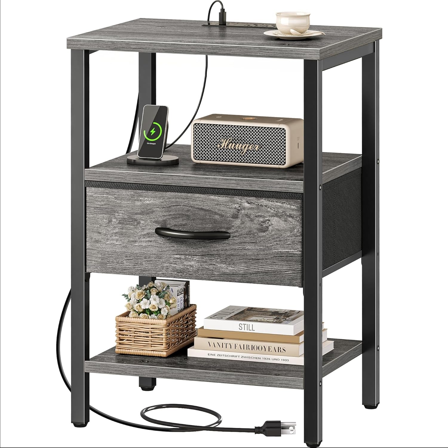 Three-quarter view of a gray wood nightstand with open shelf, fabric drawer and charging cord
