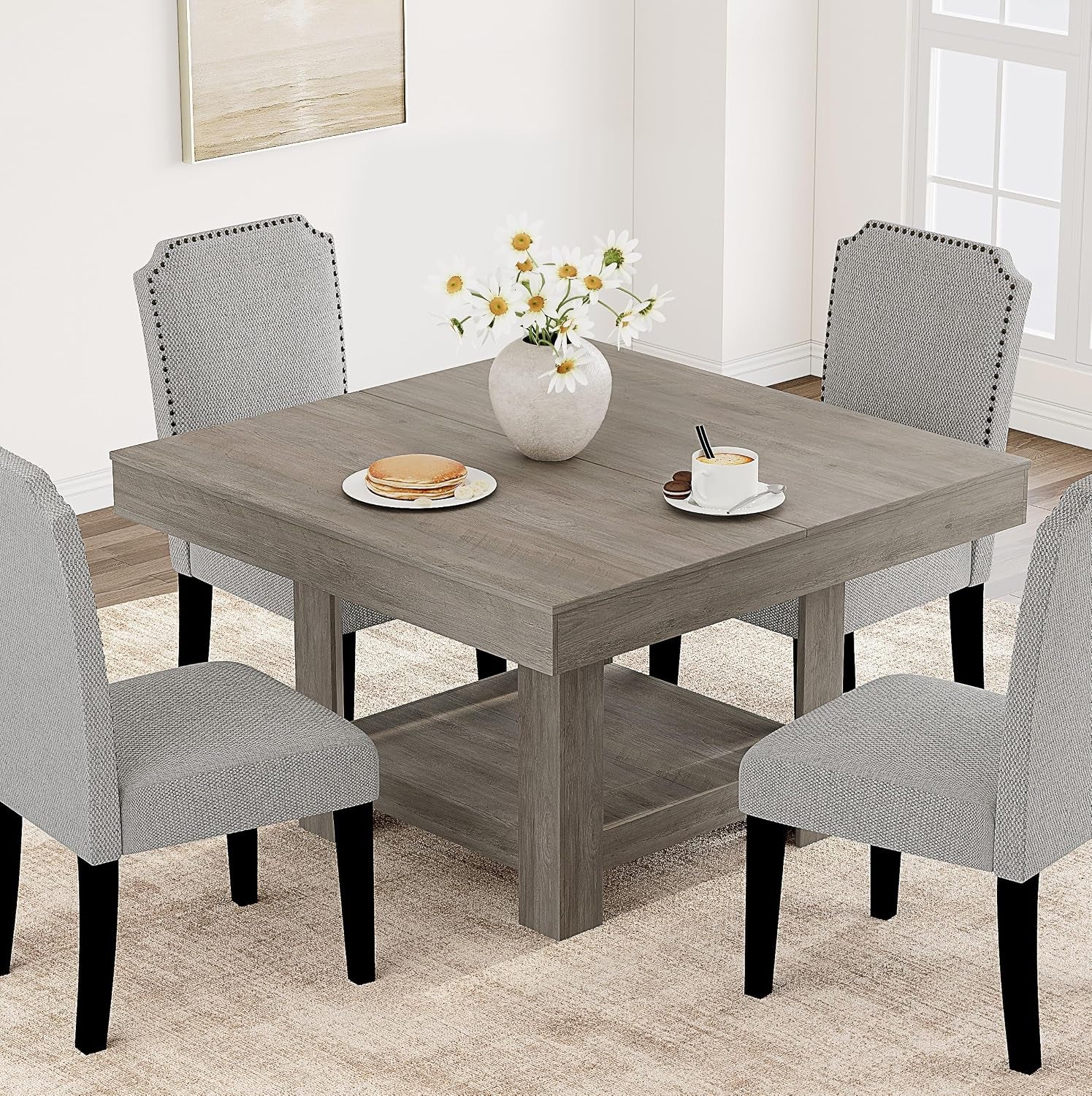 Square dining table in weathered gray finish with lower shelf, vase and place settings.