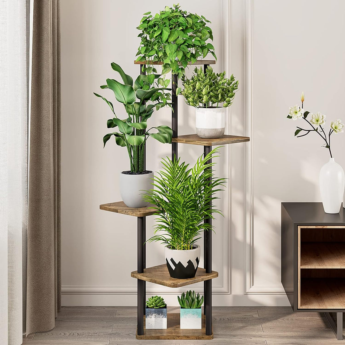 Front view of the corner plant stand with houseplants, showing shelf spacing and wood-look finishes