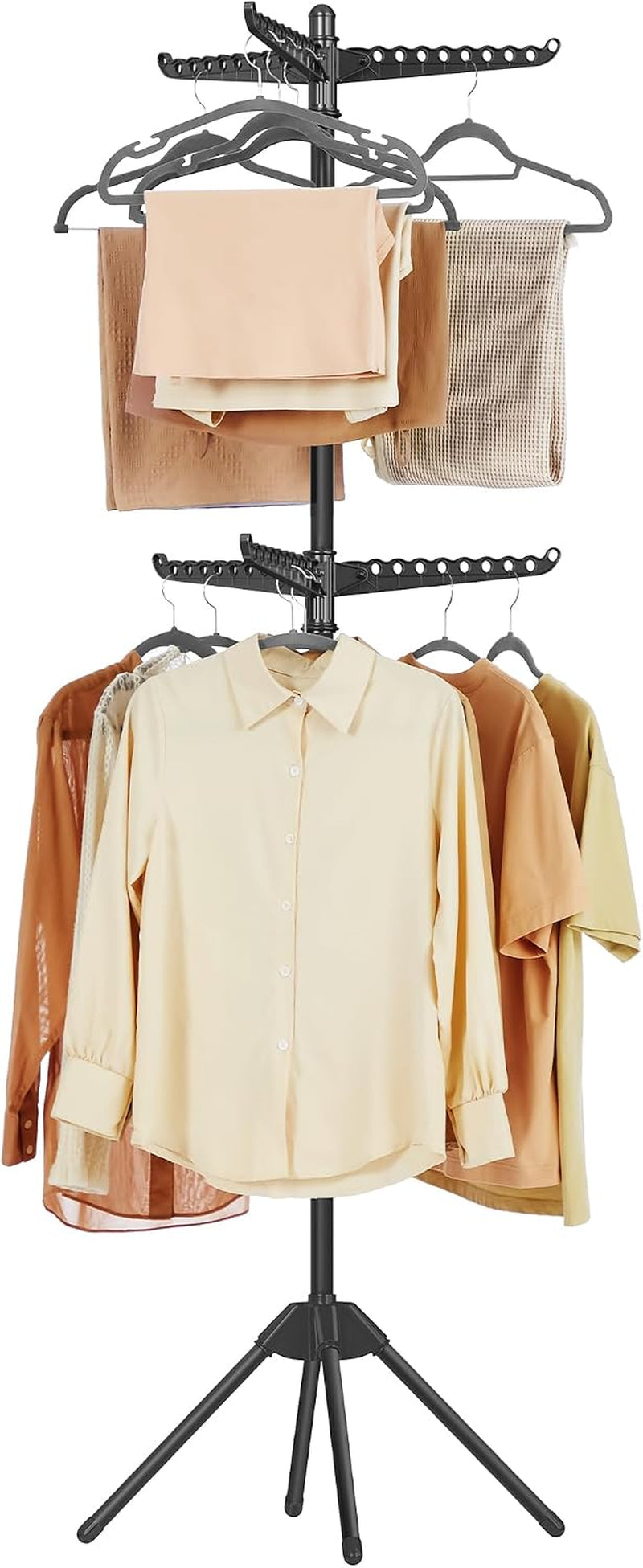 Black drying rack with arms extended, towels folded over the top and several shirts on hangers below.