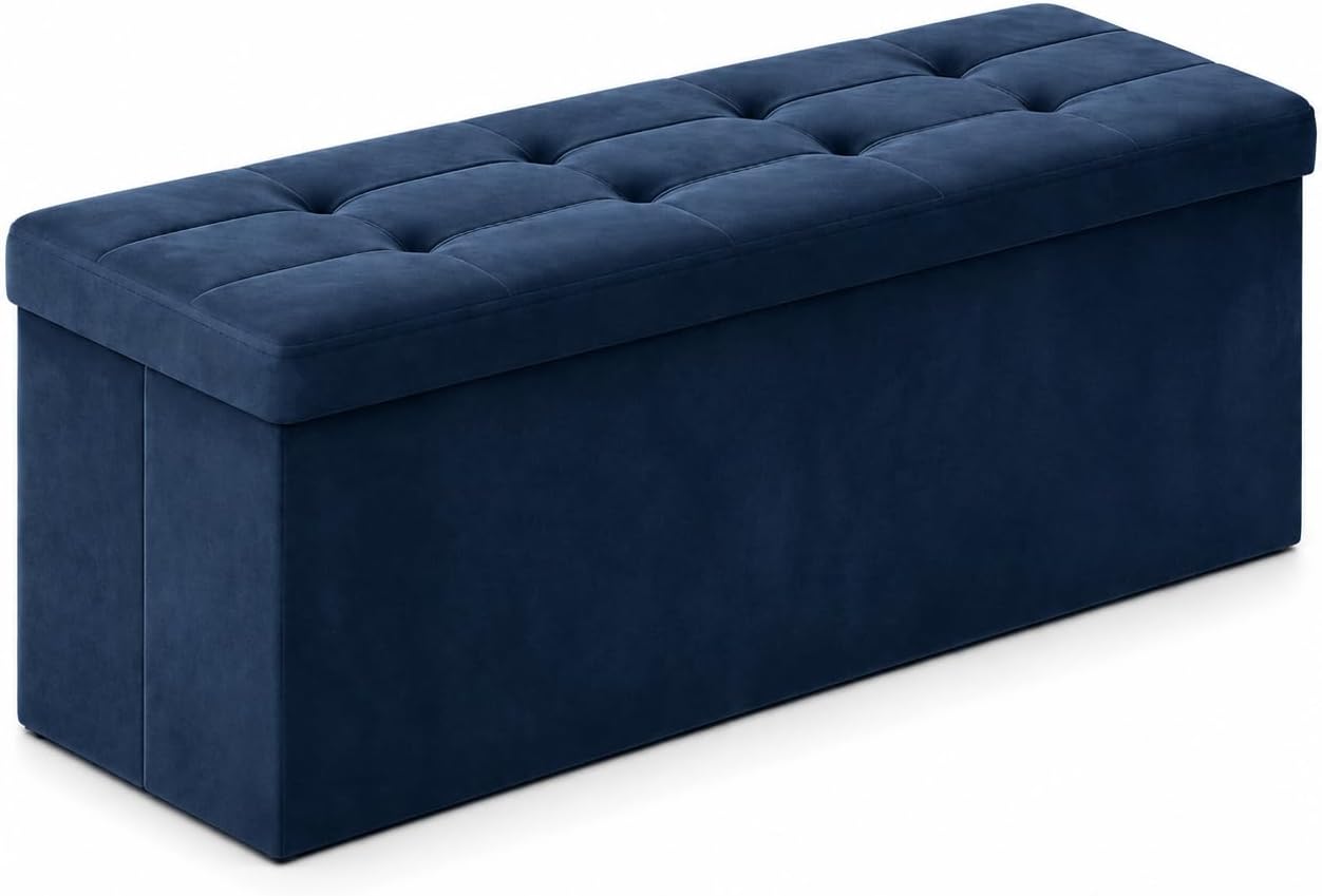 Long tufted storage ottoman shown at a three-quarter angle in deep navy blue.