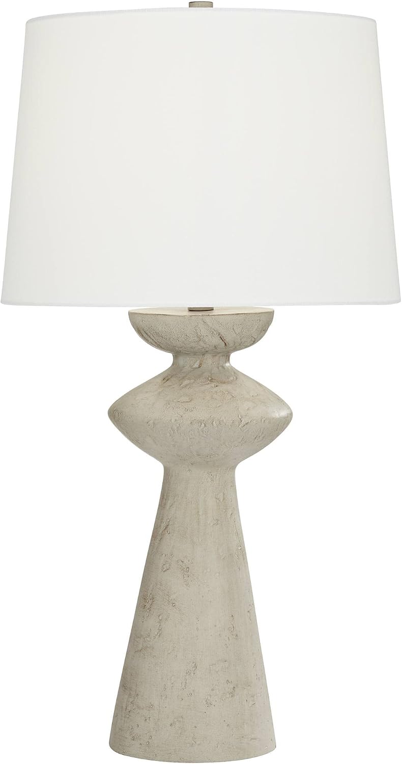 Full studio view of the grey sculptural table lamp with a white fabric drum shade on a white background