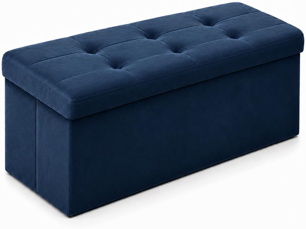 Long navy tufted storage bench ottoman shown from front-left angle