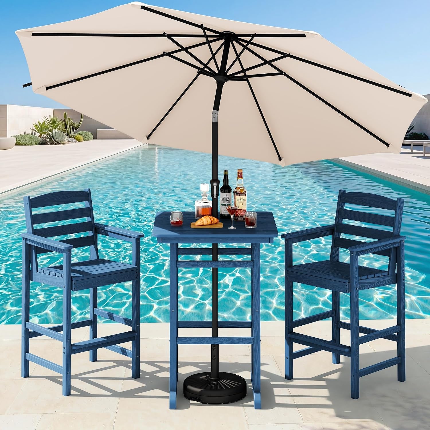 Blue bar-height table and two blue chairs by a pool with a beige patio umbrella