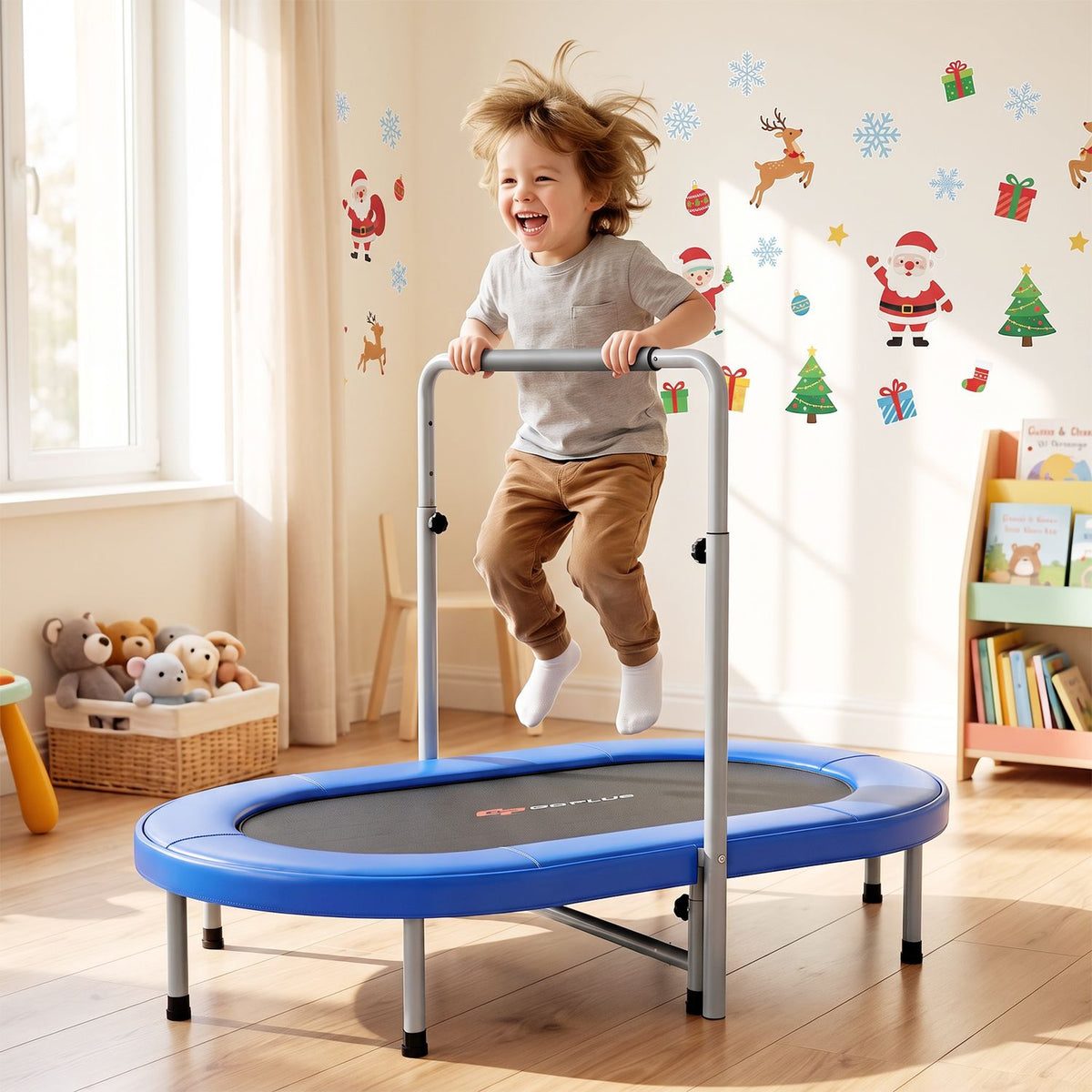 A child jumps on a blue oval trampoline with a padded handle in a bright, decorated room.