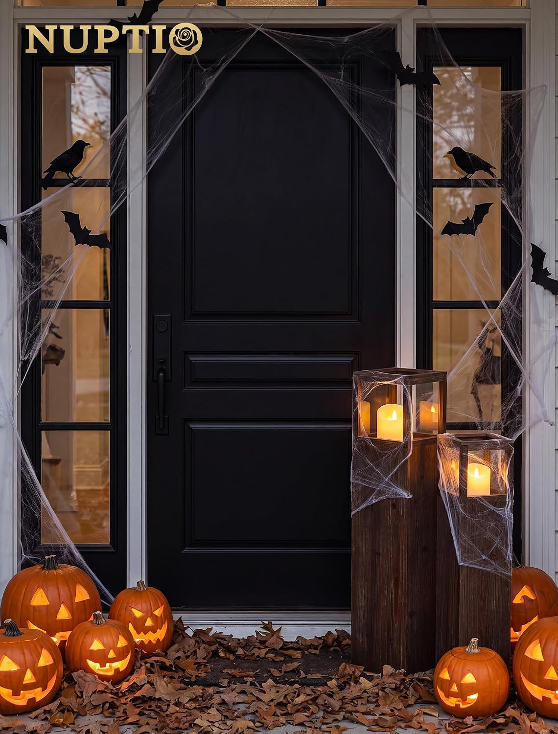 Two distressed wood lanterns styled on a front porch with Halloween decor and lit LED candles