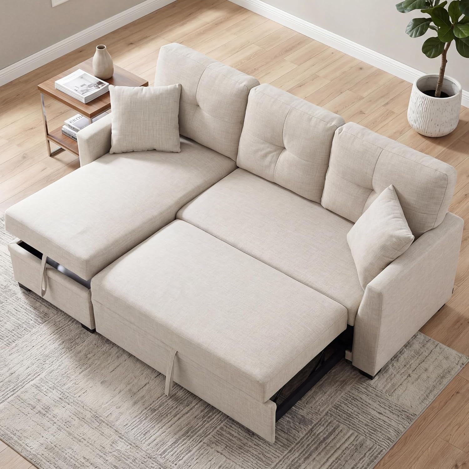 Top-down view of a beige tufted loveseat converted into a sleeper with chaise extended.