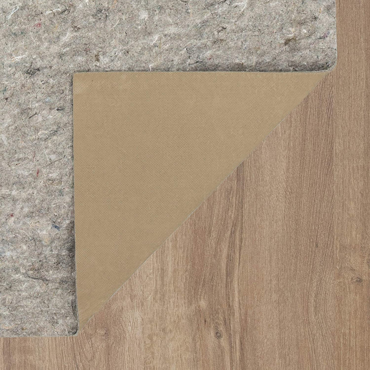 Top-down corner view showing both gray felt pad and the smooth tan underside where the corner is folded back on light wood.