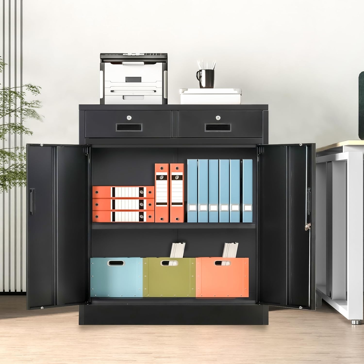 Black metal storage cabinet front view in office setting with doors open showing binders and a printer on top
