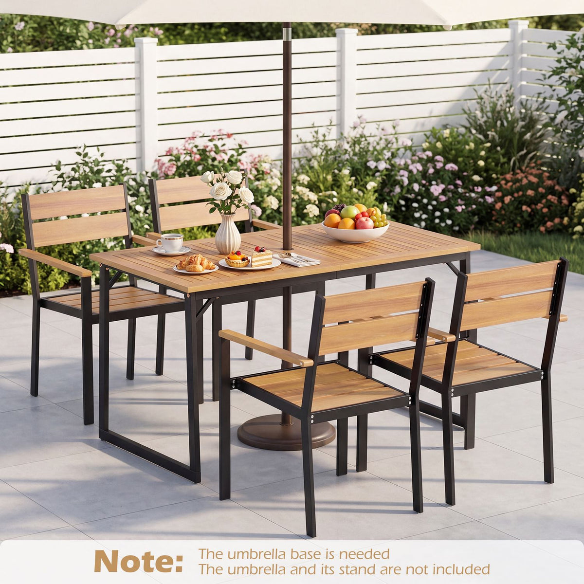 Outdoor dining table with four matching chairs beneath a large patio umbrella.