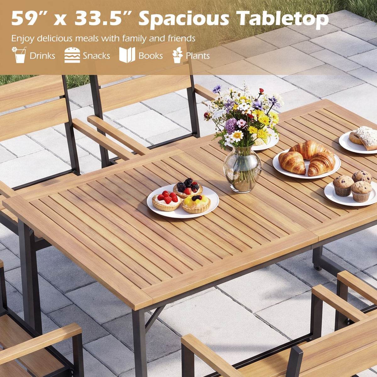 Close angled view of the slatted tabletop set with pastries, fruit, flowers, and place settings.