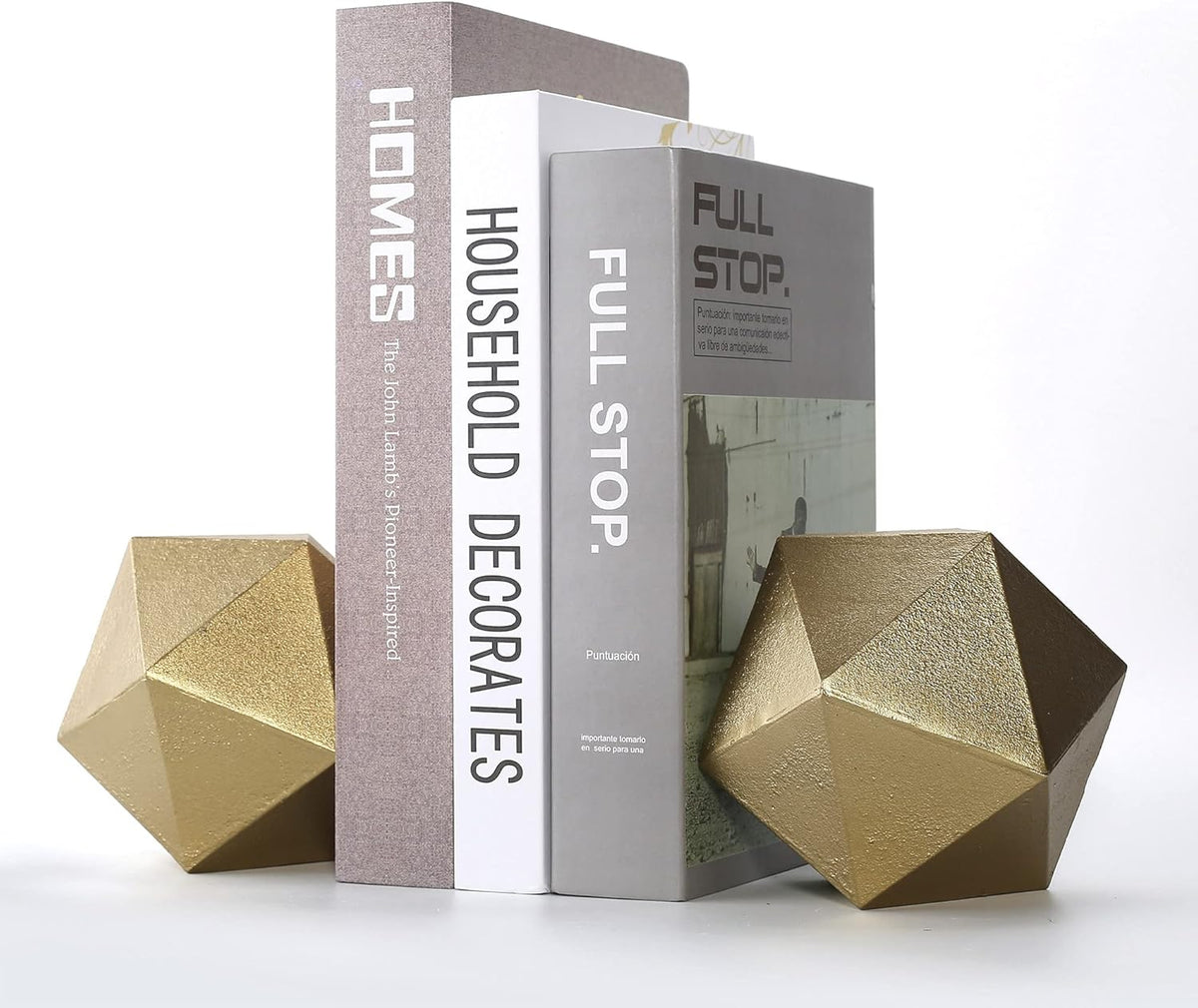 Gold geometric cast-iron ball bookends flanking three upright books, angled front view on a white background