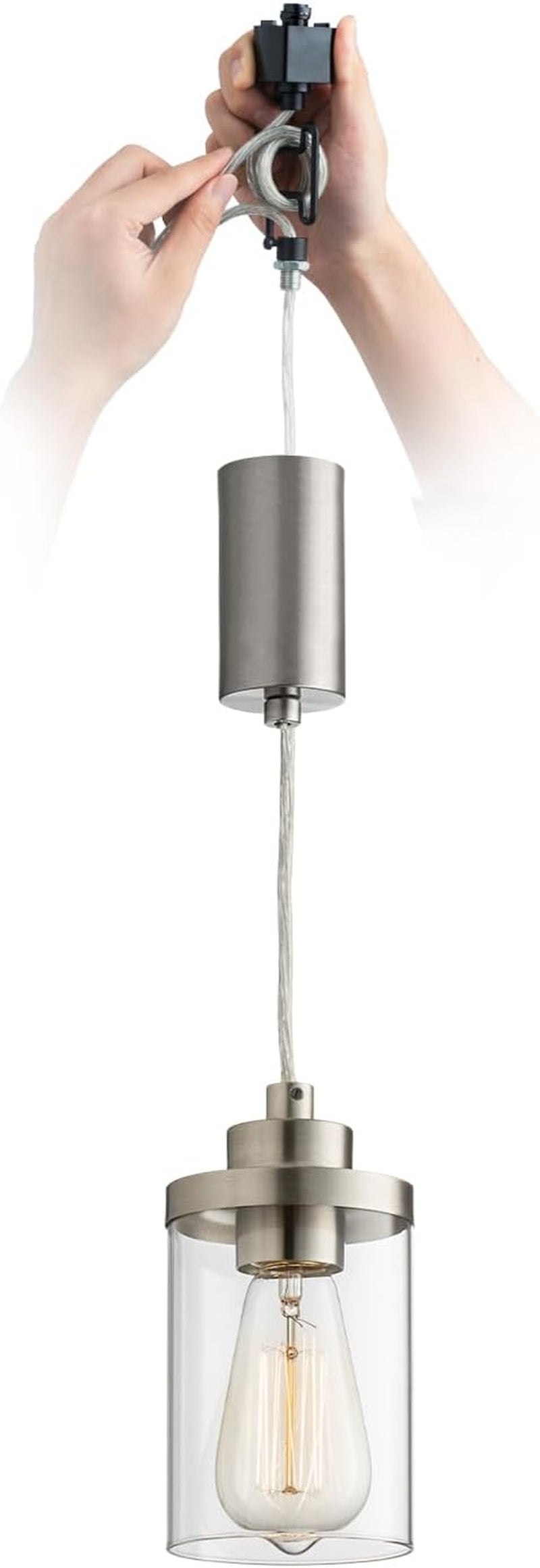 Single brushed-silver cylindrical pendant with clear glass shade and hands adjusting the track connector above