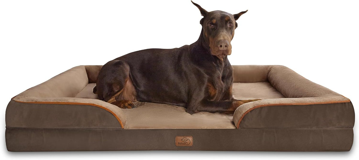 Large Doberman lying across a brown rectangular bolster bed with tan inner lining.