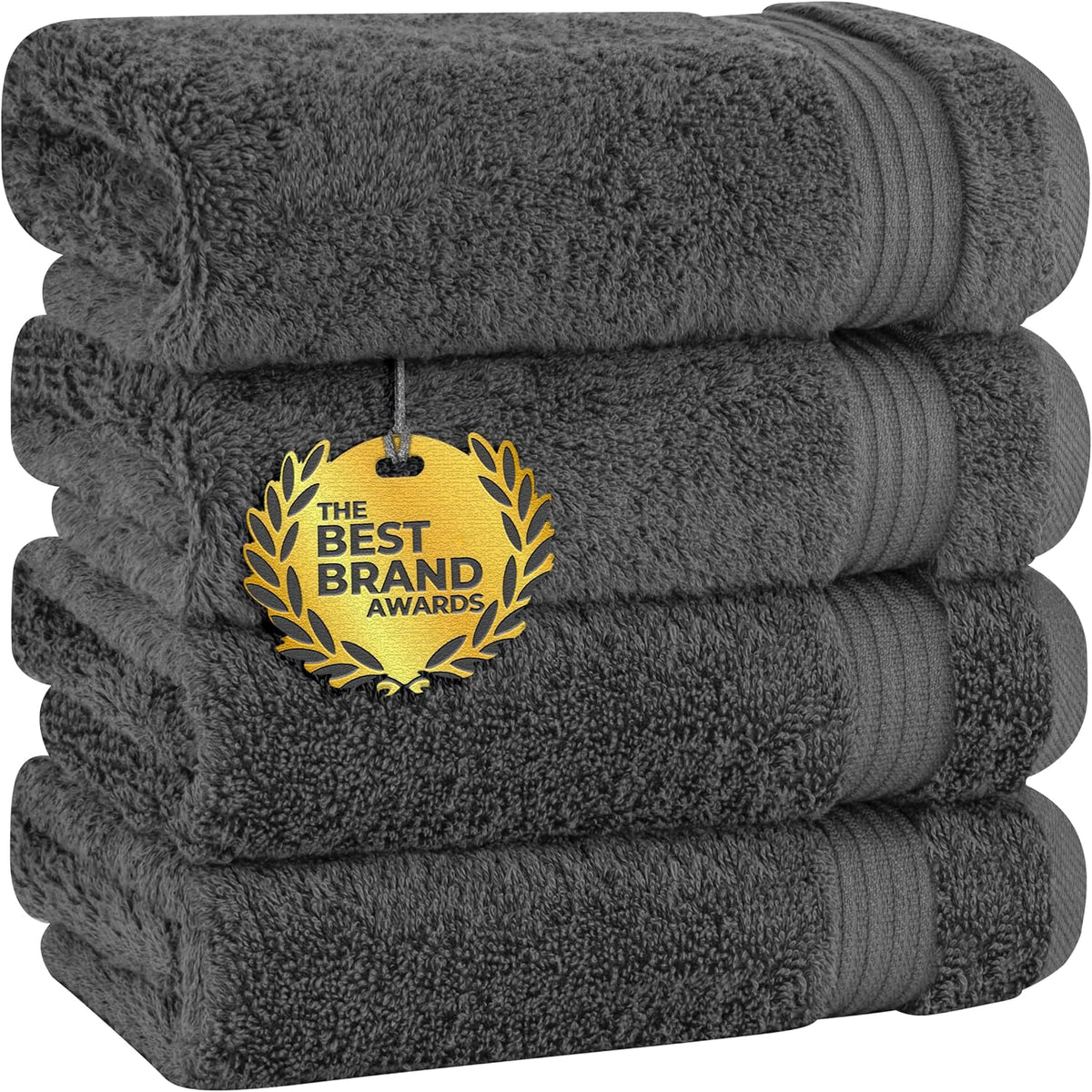 Stack of four dark gray cotton towels with rolled towel on top and a gold award medallion hanging on front