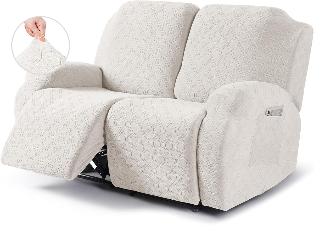 Two-seat recliner covered in textured light cream slipcover with left footrest extended