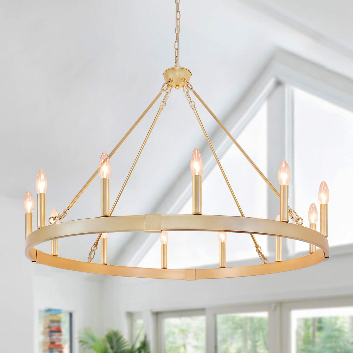 Close-up of a gold-finished orb chandelier showing the chain, canopy and top of the circular ring with lit candles