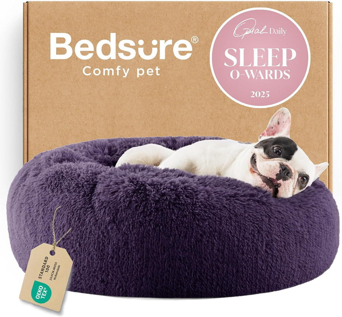 Purple round faux-fur donut dog bed with a small dog lounging in front of a cardboard box