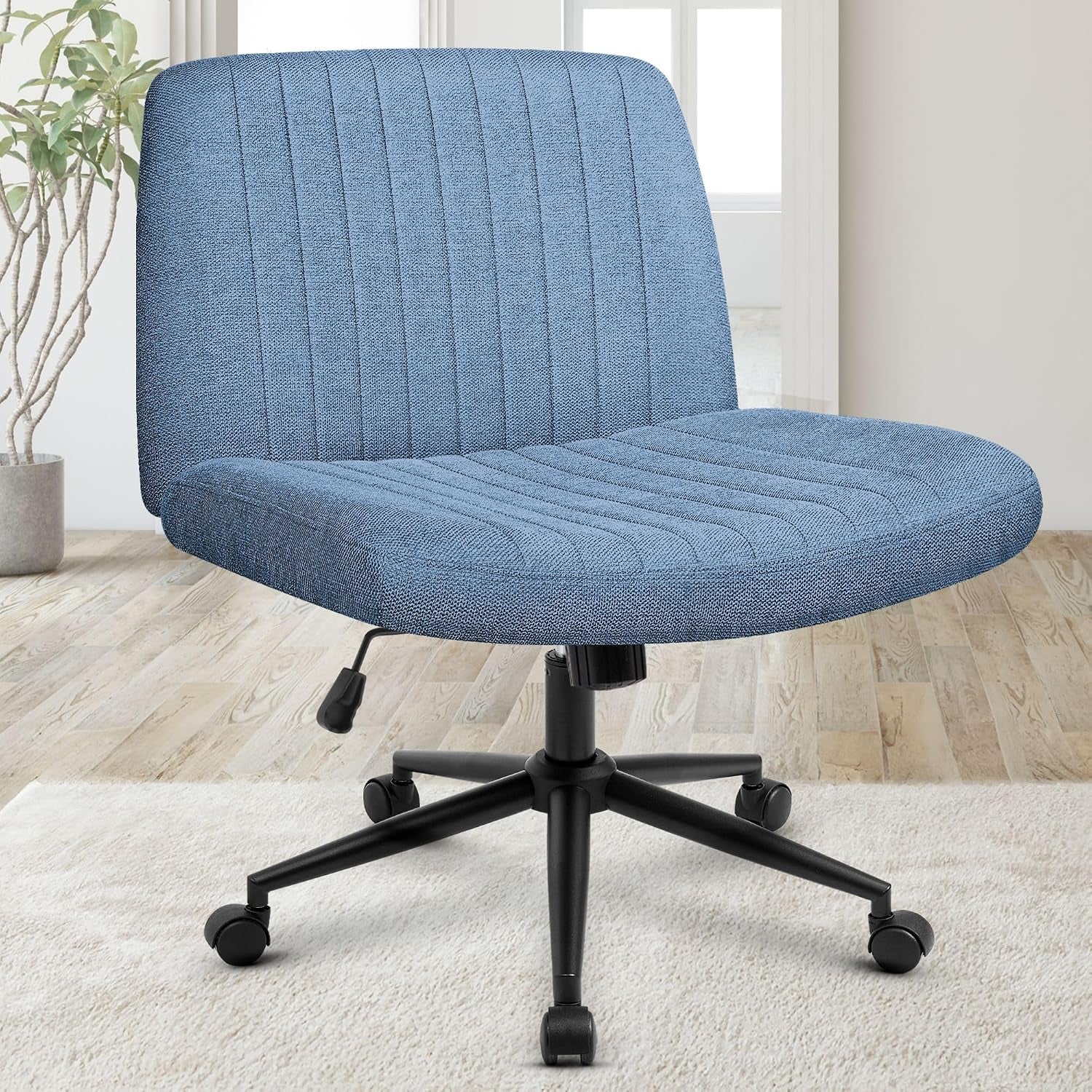 Front three-quarter view of a blue fabric swivel desk chair with vertical channel stitching and black caster base.