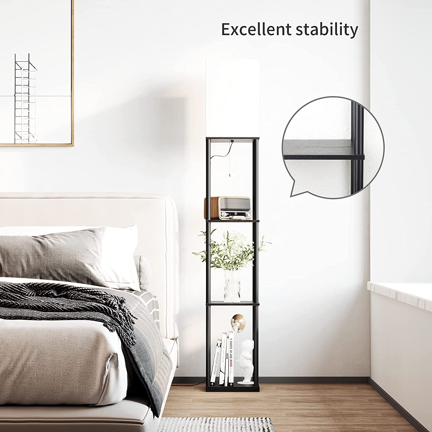 Tall black floor lamp with four open shelves standing beside a bed in a bright bedroom.