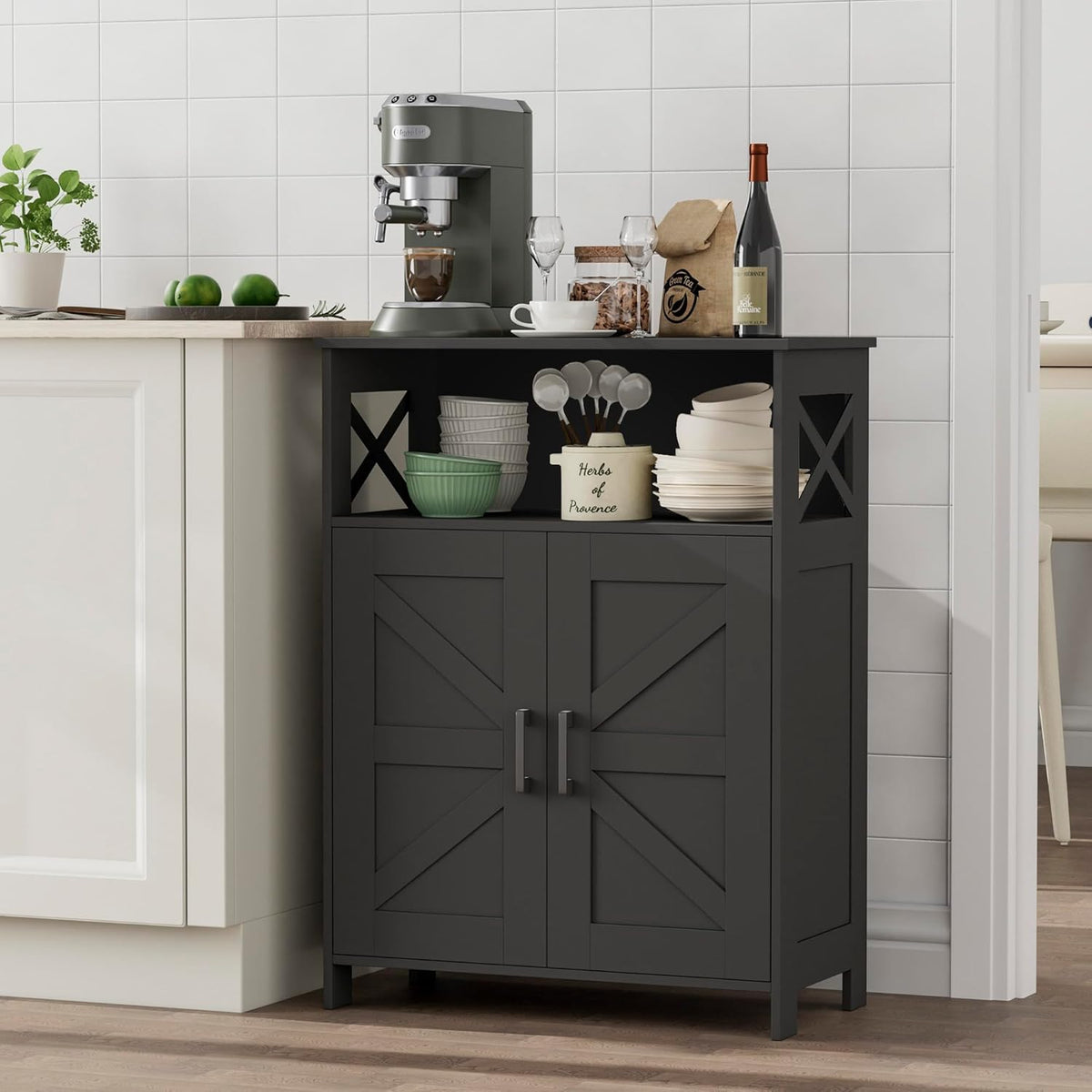 Black storage cabinet placed beside a kitchen counter holding bowls, plates and a coffee machine on top.