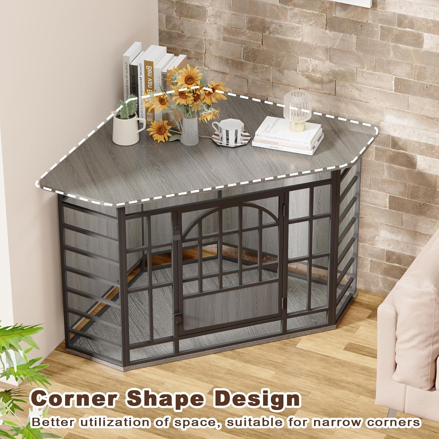 Angled view of a grey wood-top corner dog crate placed in a living room corner with a lamp and decorative items on the top
