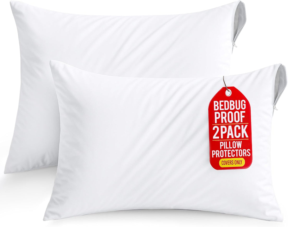 Two white zippered pillow protectors stacked, front tag visible on the lower cover.