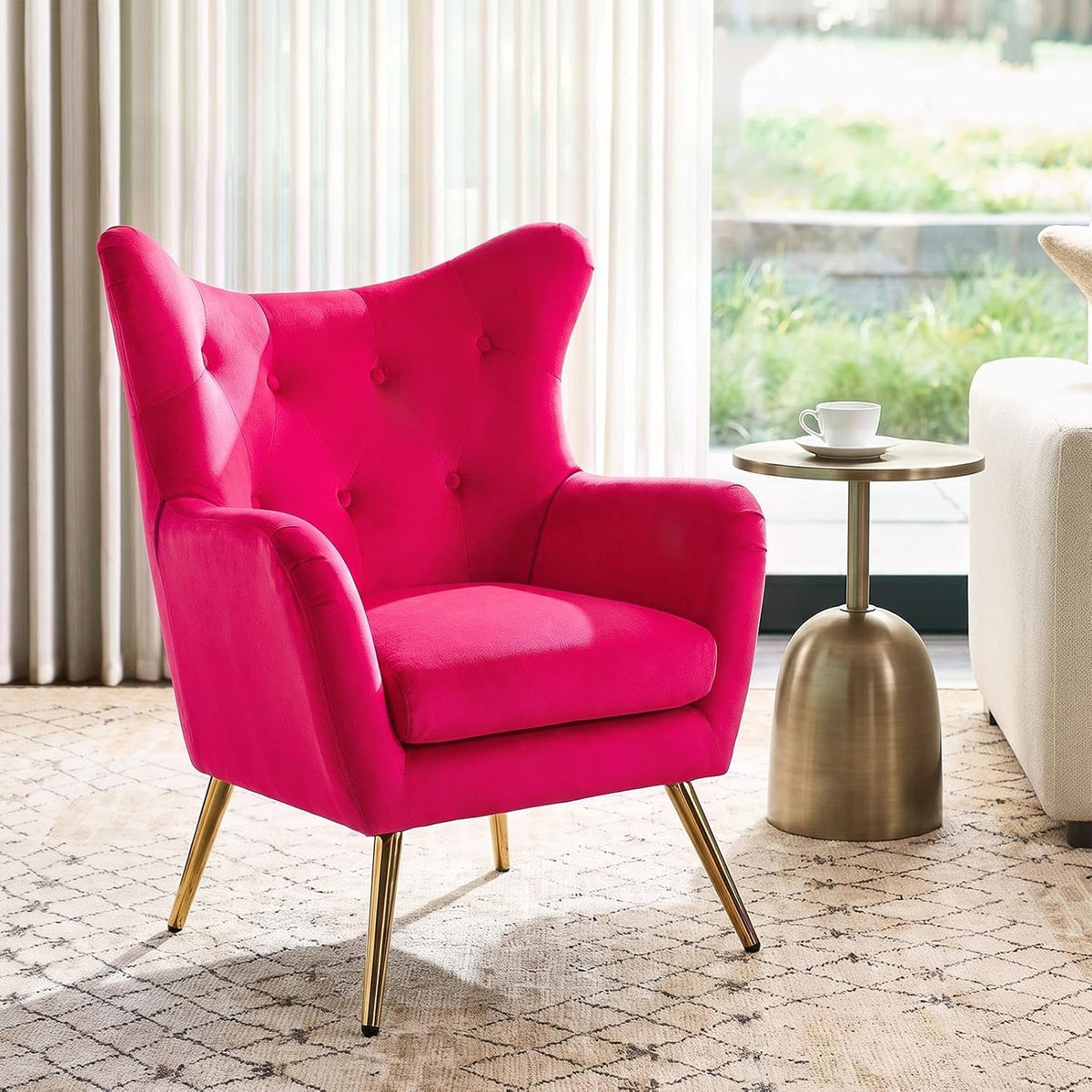 Bright fuchsia wingback chair shown from a similar angle, highlighting button tufting