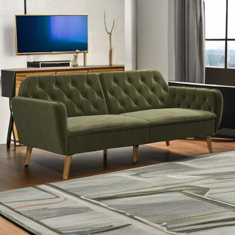 Green velvet tufted futon sofa bed staged in a modern living room with TV console in background