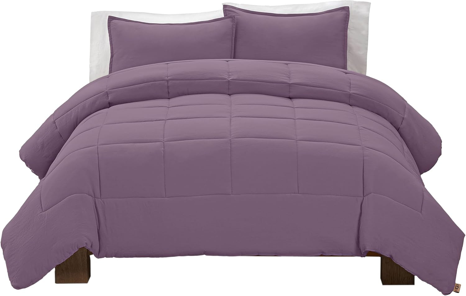 Front-facing view of a purple box-stitched comforter and two matching shams on a low platform bed
