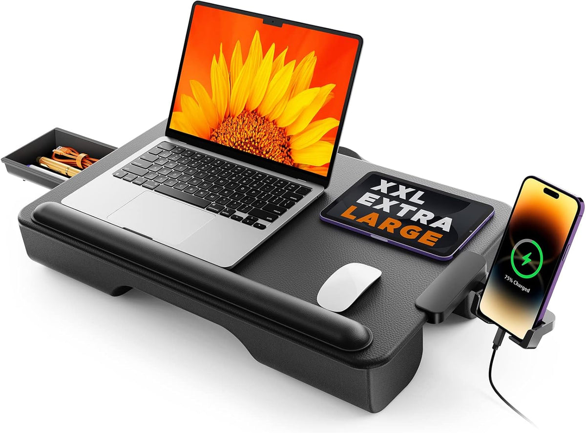 Black cushioned lap desk on white background with laptop, tablet, mouse and a phone dock attached