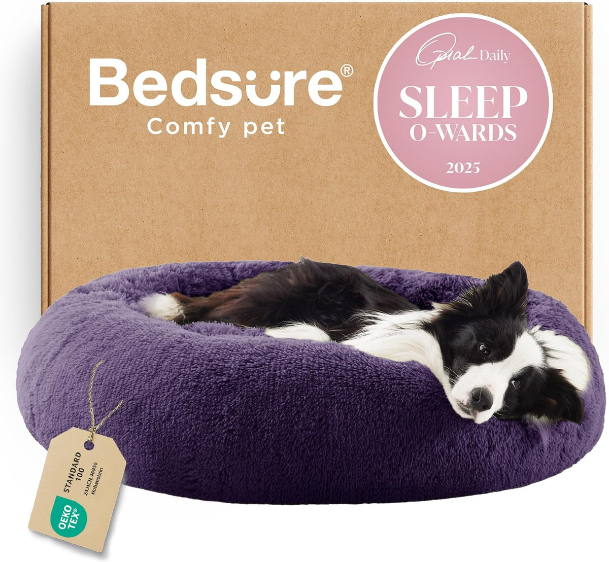 Low-angle view of a purple fluffy donut bed with a black-and-white dog resting and a cardboard box behind.