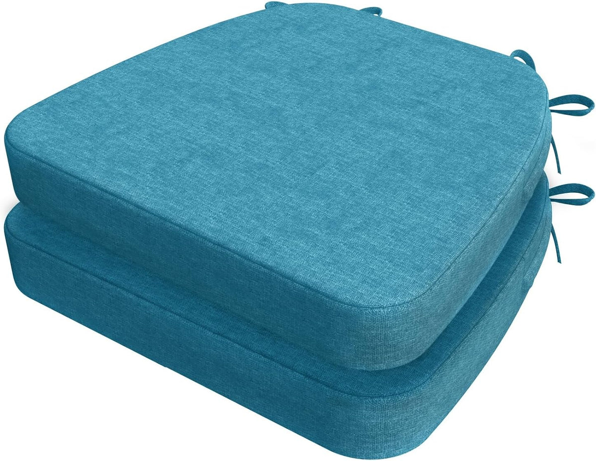 Two teal D-shaped chair cushions stacked, angled top view showing top surface and ties at the rear.