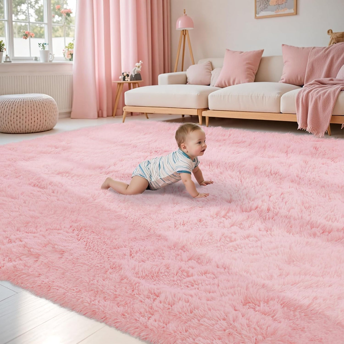 Main room shot of a soft pink shag rug with a baby crawling and coordinating pink curtains and sofa.
