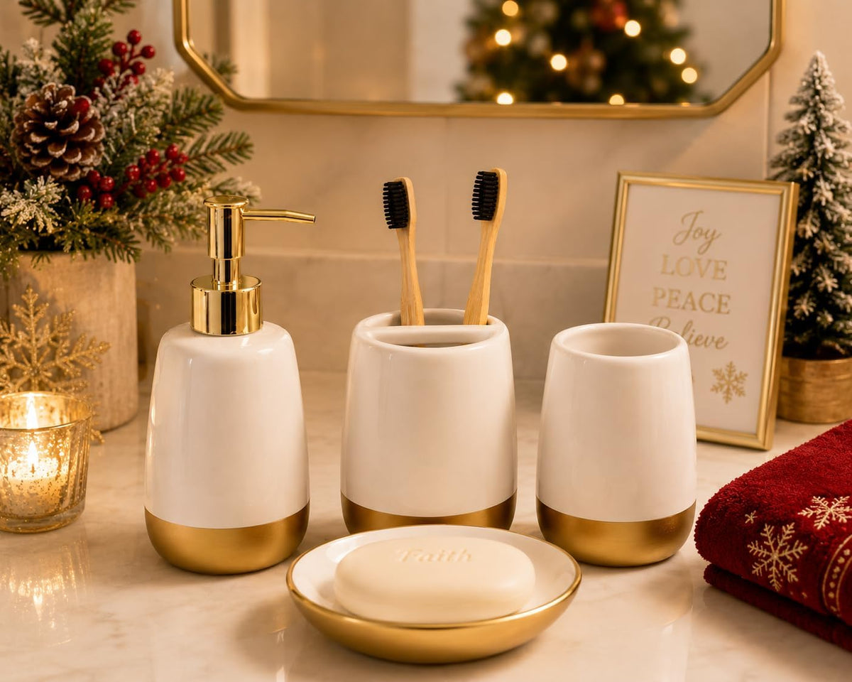 White ceramic set with gold accents styled with candles and holiday decor on a marble countertop