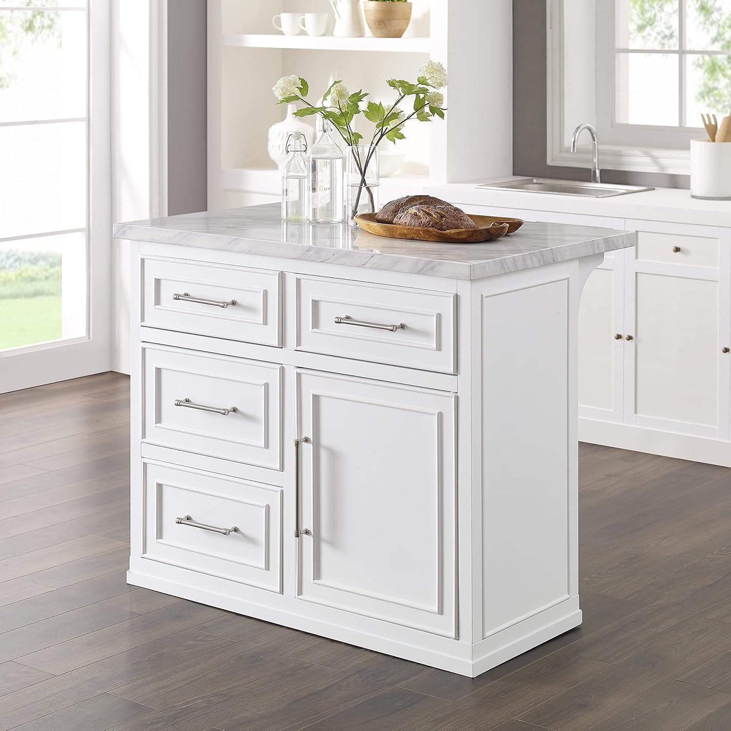 Staged kitchen scene with white island centered showing built-up faux marble countertop and overhang designed for stools