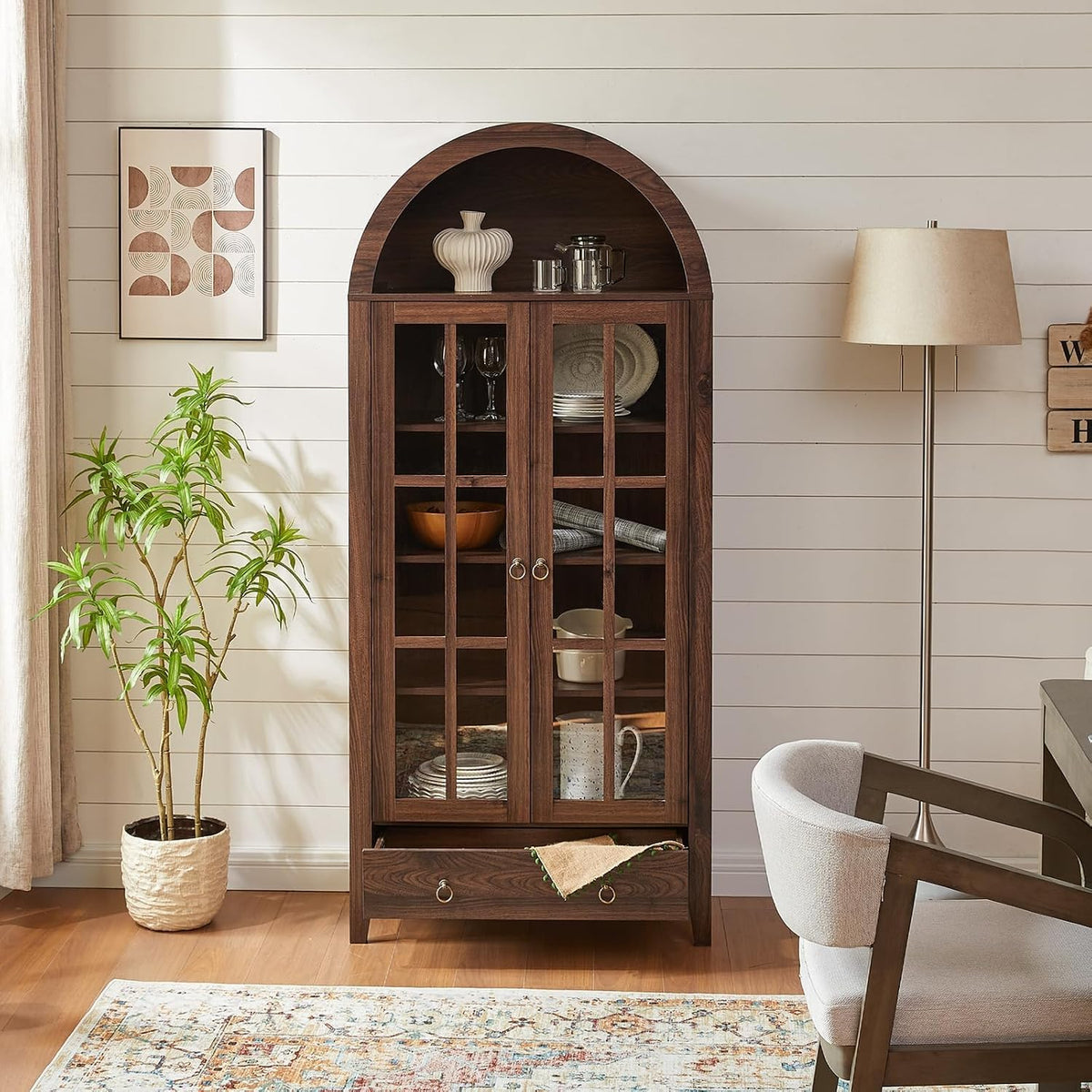 Brown arched glass-door cabinet bookshelf displayed in a dining area