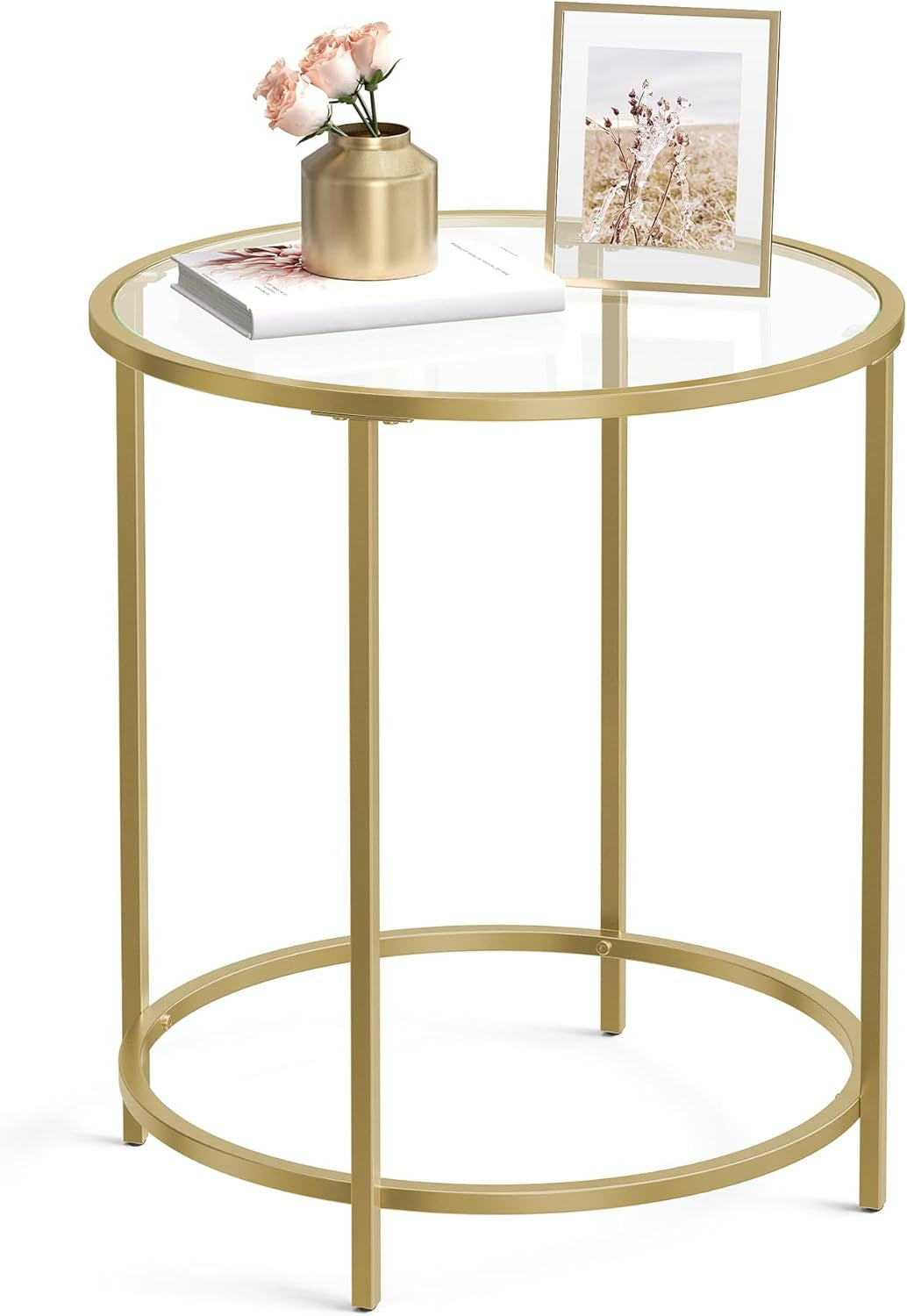 Round gold-colored steel frame side table with clear tempered glass top, angled close-up front view