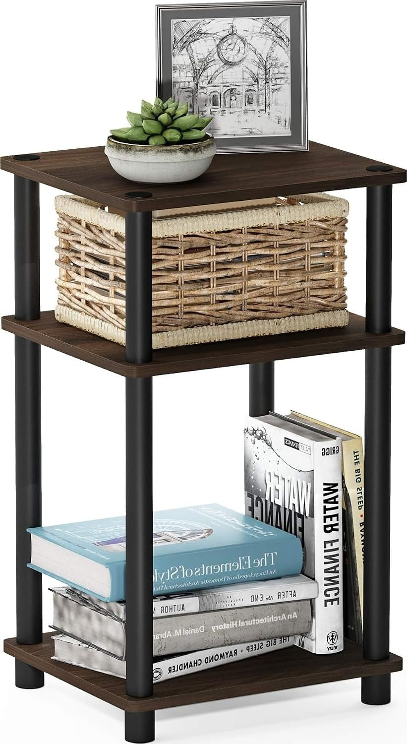 Dark wood three-tier end table with black legs holding a woven basket and stacked books.