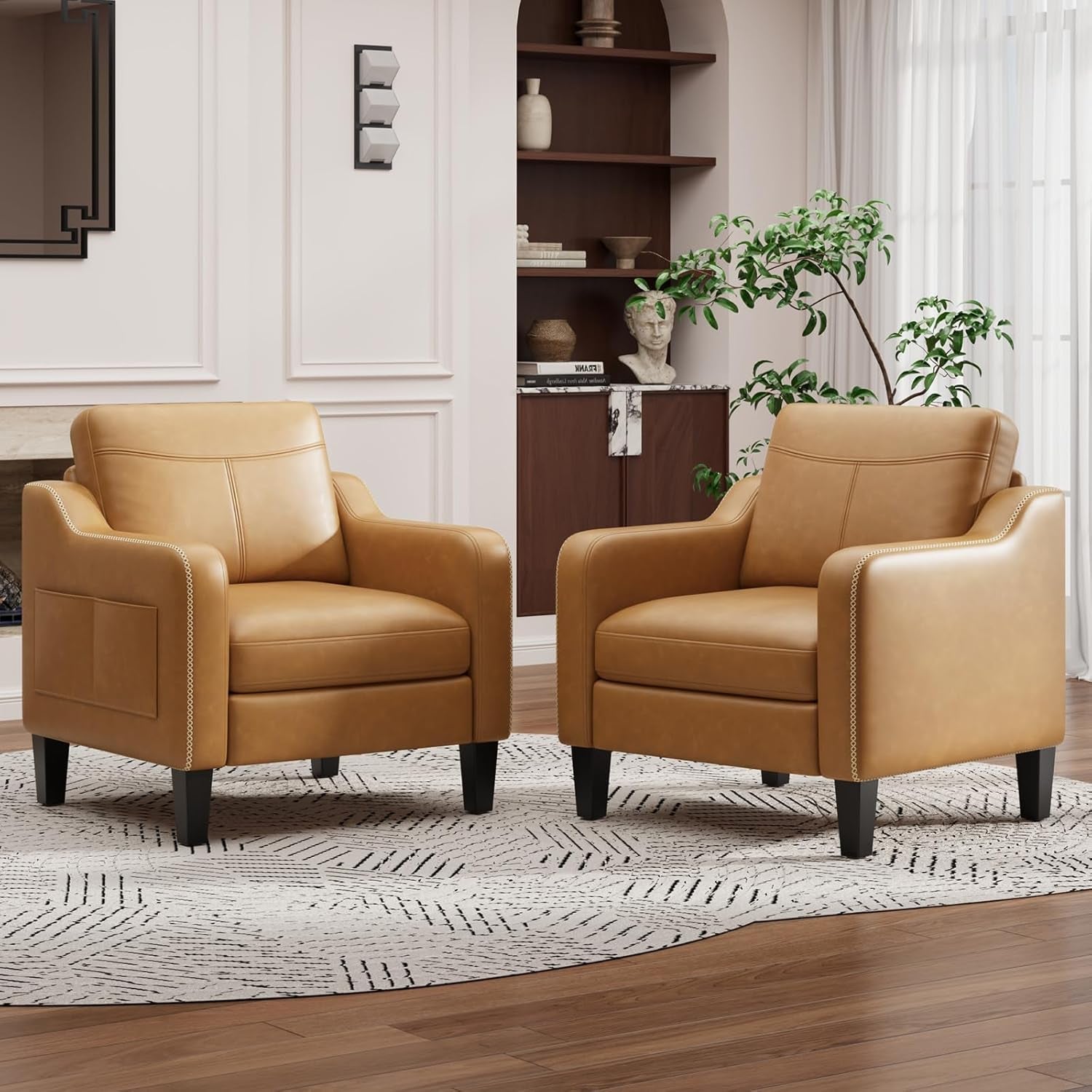 Two camel-tan PU leather armchairs positioned together in a bright living space.