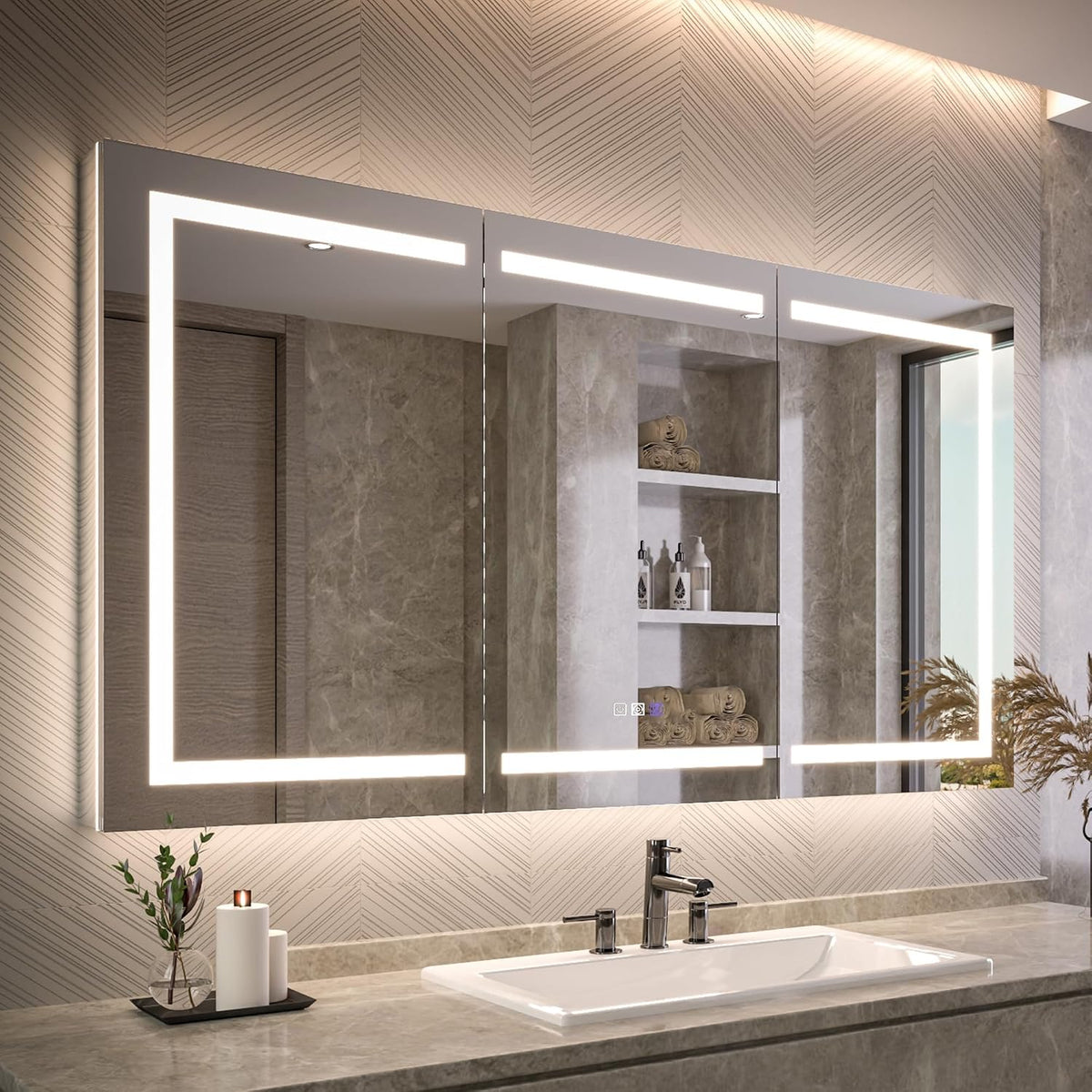 Wide view of the large illuminated medicine cabinet above a rectangular sink with patterned wall and decorative foliage
