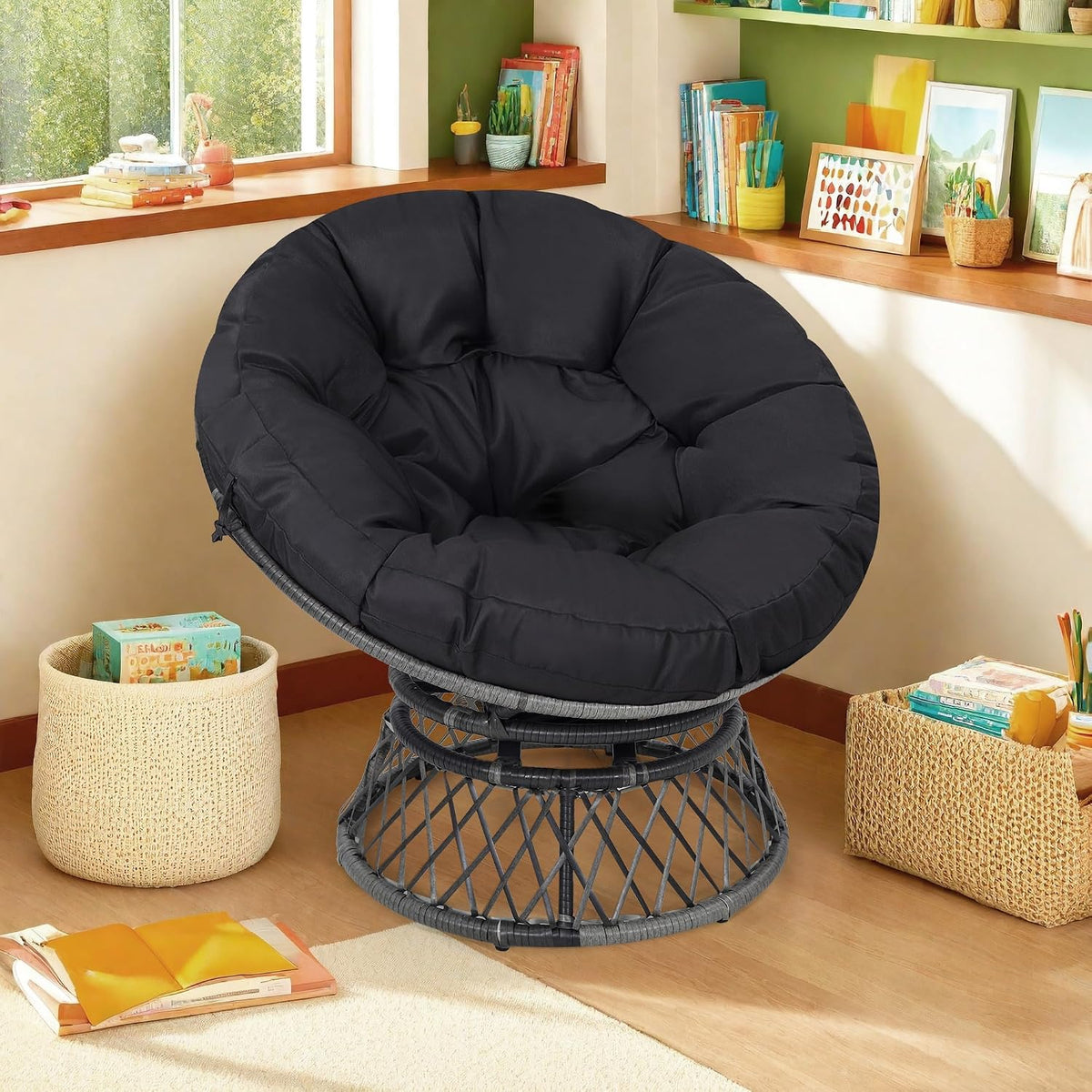 Black-cushioned wicker papasan chair placed in a cozy corner beside woven baskets and a window ledge.