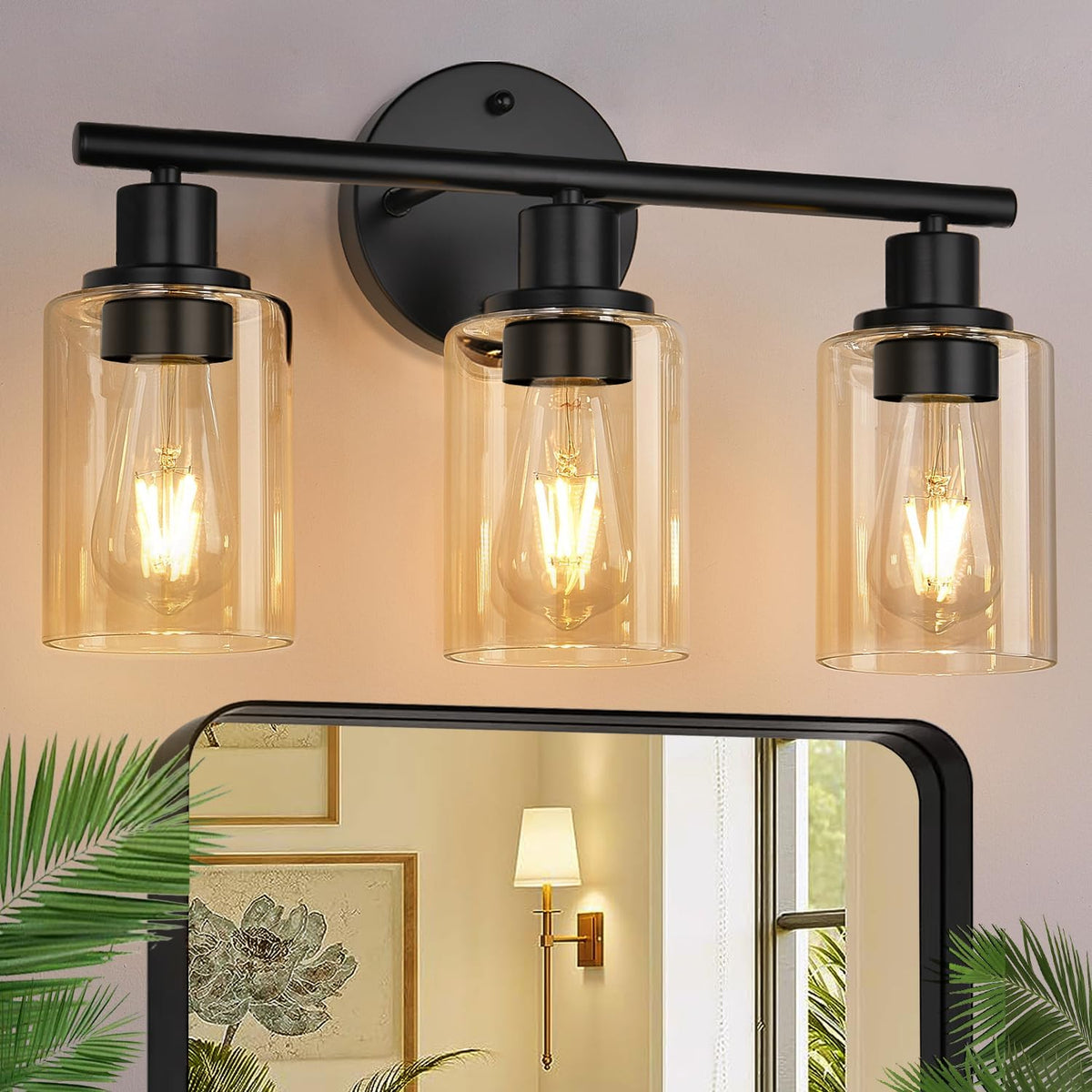 Front close-up of a three-light matte black vanity fixture with amber-tinted clear glass shades and lit filament bulbs.